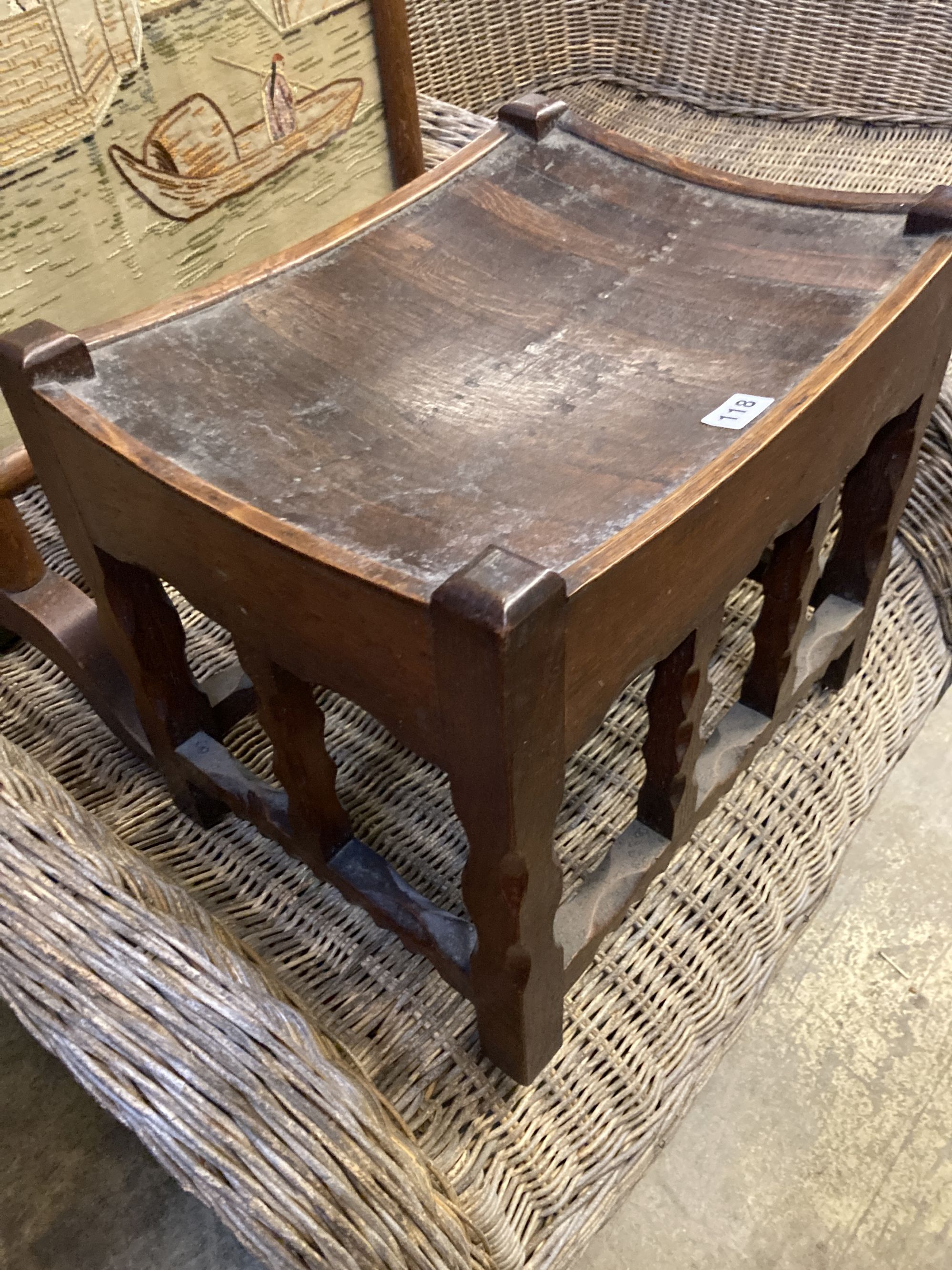 An Arts & Crafts rectangular chip carved oak stool, width 43cm, depth 34cm, height 38cm, together with an embroidered firescreen